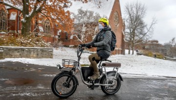 A winter commuter passes near Sage Chapel.