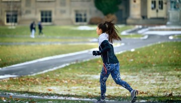 A student runs through the Arts Quad on a chilly December day. 