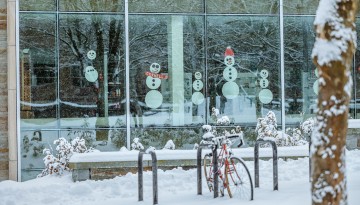 Snowmen celebrate the first snowfall of 2022 from inside Gannett Health Center.