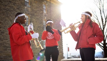 Members of the Big Red Marching Band gather for an impromptu performance on the Arts Quad.
