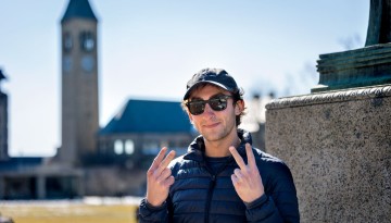 A student poses in front of McGraw Tower before class.