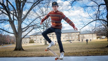 A student skates on the Arts Quad.