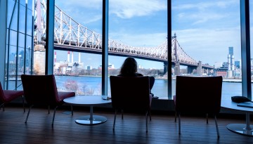 A student enjoys the view from the Tata Innovation Center at Cornell’s Tech Campus in New York City.