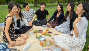 A group of friends picnic on the Arts Quad.
