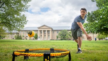 Students play spike ball on the Arts Quad.