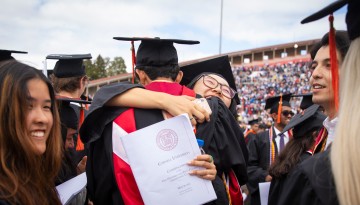 Graduates embrace. 