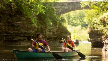 Students canoe around Beebe Lake with the help of the Cornell Outdoor Education program for Senior Days.
