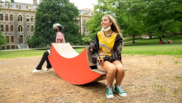 Summer program students relax on the Arts Quad.