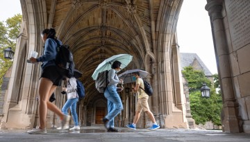 Students pass through the War Memorial on a rainy day.