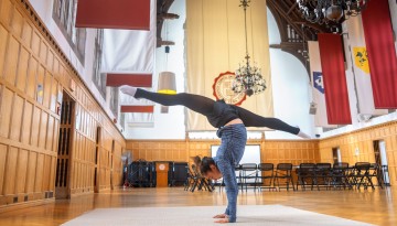 A student does yoga in Willard Straight Hall.