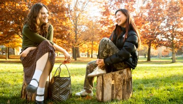 Students hang out on the Arts Quad near Sibley Hall on an autumn day.