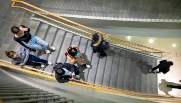 Students descend a staircase in Statler Hall after class lets out.