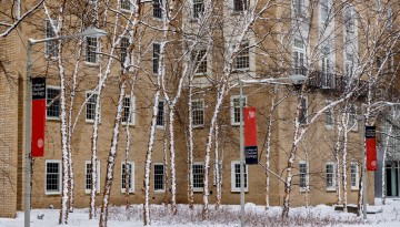 Snow clings to trees outside Martha Van Rensselaer Hall after a winter storm.