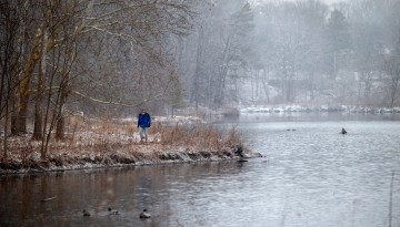 A man takes a walk in the snow by Beebe Lake.