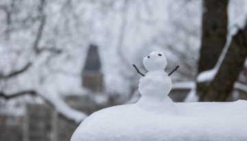 Miniature snowman sits along Feeney Way near Lincoln Hall.