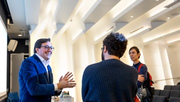 Dr. Dario Gil, left, of IBM speaks with students in Gates Hall during a visit to campus.