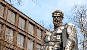 Herakles statue watches over comings and goings by Uris Hall. 