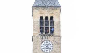 People watch the parade from atop McGraw Tower.