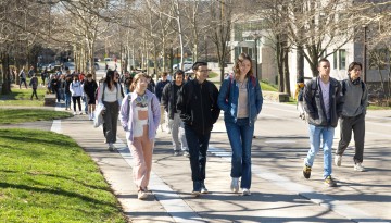 Students walk on Ho Plaza on a warm spring day