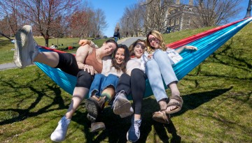 Students gather on a hammock on Libe Slope.