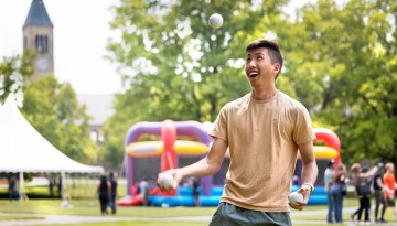A student juggles during the Senior Days Carnival on the Arts Quad.
