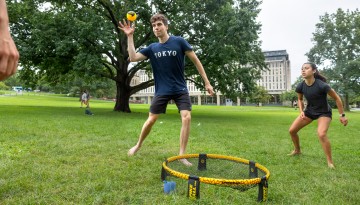 Students play spikeball on the Arts Quad.