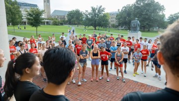 Cornell Running Club congregates in front of Goldwin Smith Hall.