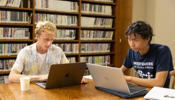Students work in Uris Library.