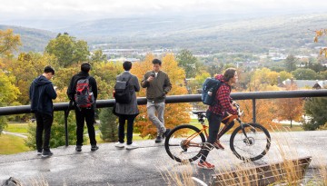 Community members enjoy the fall vista from the top of Libe Slope.