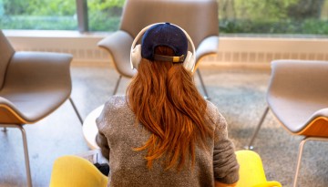 A student works with headphones on in Upson Hall.