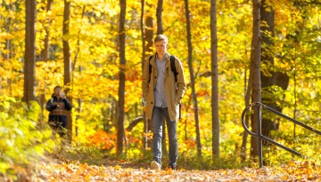 Students take an autumn walk through the Cascadilla Gorge Trail near Rhodes Hall.