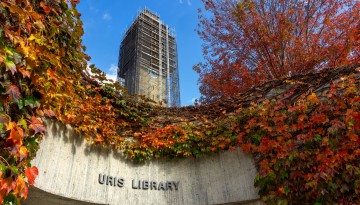 Autumn foliage at Uris Library with the McGraw Tower renovation in the background.