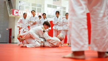 Students in Kevin Seaman’s Brazilian jiu-jitsu class practice in Bartels Hall.