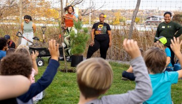 Colah B. Tawkin, Black Plant media curator and storyteller, leads a tree planting session at the Ithaca Children’s Garden.