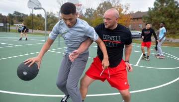 Members of the Cornell University Police Department and resident assistants from North Campus participate in a basketball tournament at the Jessup Field courts.