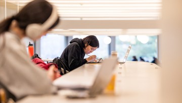 Students study for winter exams in the cocktail lounge of Uris Library.
