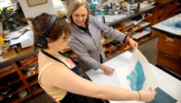 A student works on a monotype print in Tjaden Hall.