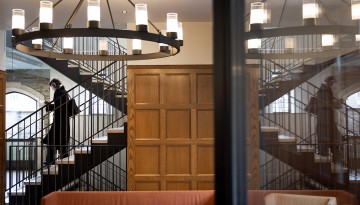 A student descends the staircase in Myron Taylor Hall.