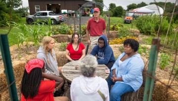 Students and staff meet at a Dilmun Hill student farm open house.