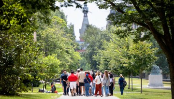 A summer tour group makes its way through the Arts Quad.