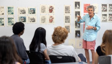 Summer printmaking class students participate in a critique session in Tjaden Hall.