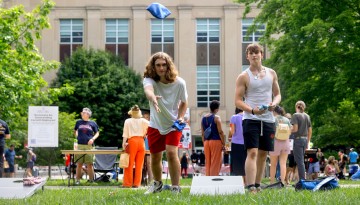 Students play a game of cornhole during Cornell Summer Wellbeing Adventure’s Chillin’ on the Quad Party. 