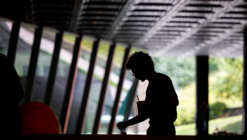 A student works on an art project under Milstein Hall.