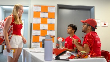 A student checks in with volunteers. 