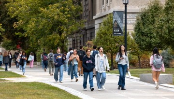 Students cross the Ag Quad on a warm afternoon.
