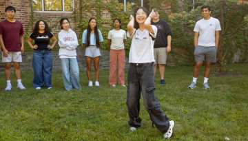 Students participate in an ice-breaker activity in front of Olin Hall.