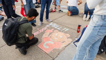 Students participate in the Chalk Challenge event during Spirit Week on Ho Plaza.