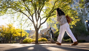 A student crosses Peter Plaza on the way to morning class.