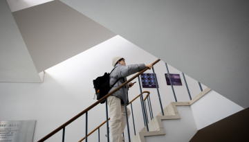 A student climbs the stairs of Malott Hall.