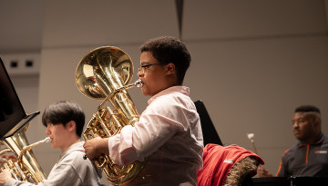 Members of Cornell Wind Symphony rehearse with Film composer Michael Abels in Bailey Hall.